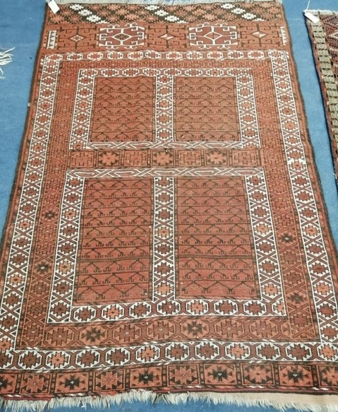 An Afghan terracotta ground rug 180 x 120cm